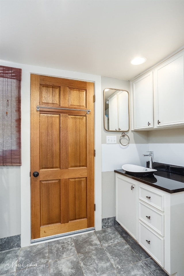 kitchen featuring white cabinetry and sink