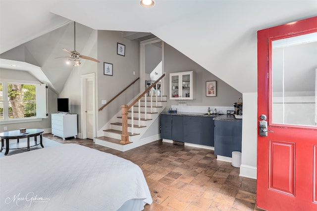 bedroom featuring lofted ceiling, dark parquet floors, and bar area