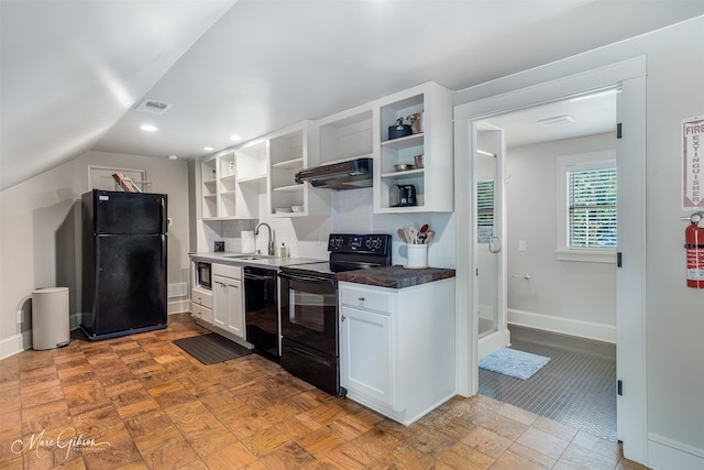 kitchen with lofted ceiling, sink, black appliances, white cabinets, and decorative backsplash