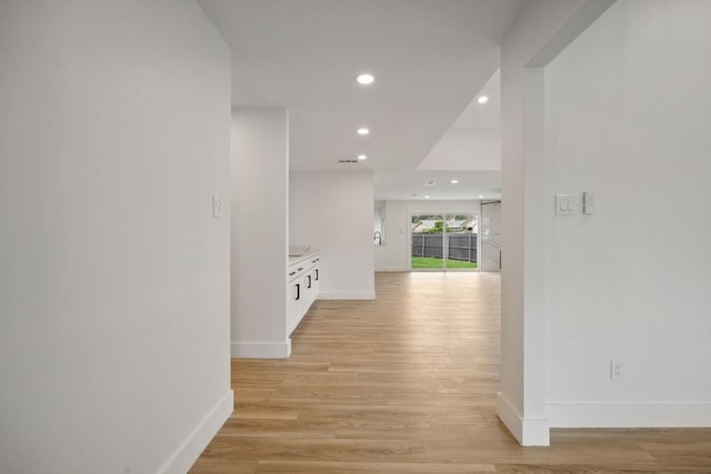 hallway with light hardwood / wood-style flooring