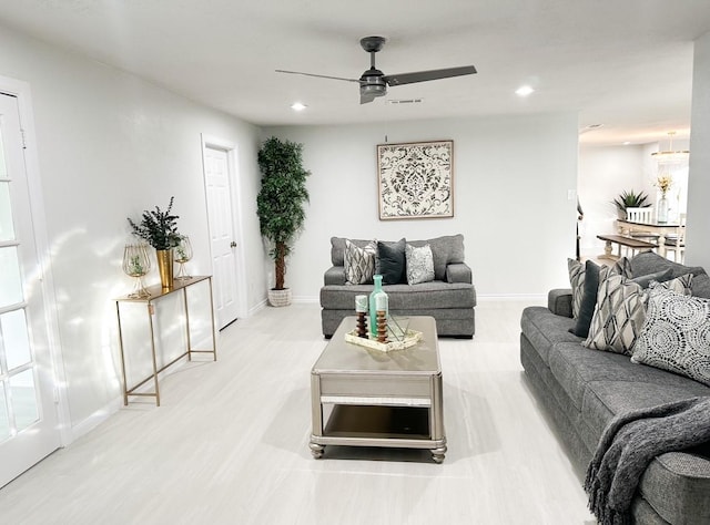 living room with ceiling fan and light hardwood / wood-style floors