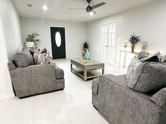 living room featuring french doors and ceiling fan