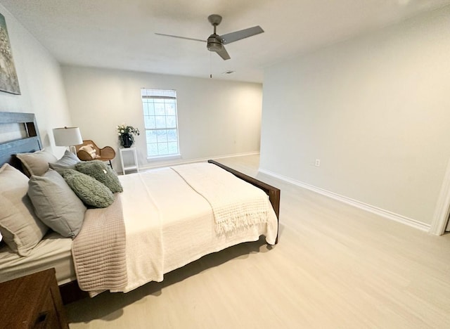 bedroom with ceiling fan and light hardwood / wood-style floors