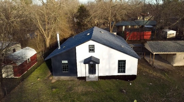 rear view of house featuring a lawn