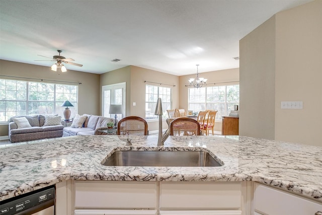 kitchen featuring white cabinetry, ceiling fan with notable chandelier, dishwashing machine, and sink