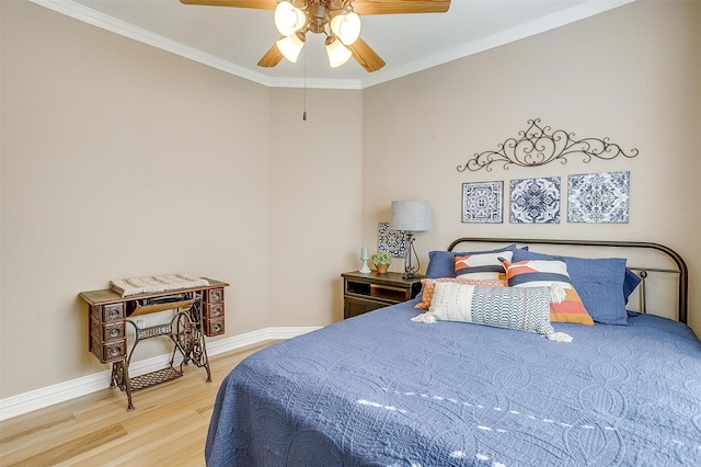 bedroom featuring ceiling fan, ornamental molding, and hardwood / wood-style floors