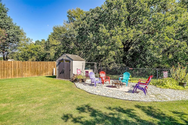 view of yard with a storage shed and a fire pit