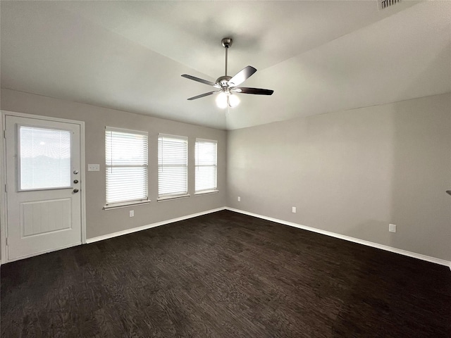 interior space featuring vaulted ceiling, dark hardwood / wood-style floors, and ceiling fan