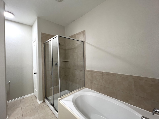 bathroom featuring tile patterned flooring and plus walk in shower