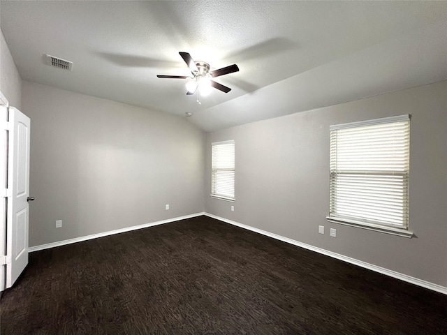 unfurnished room featuring lofted ceiling, dark hardwood / wood-style floors, and ceiling fan