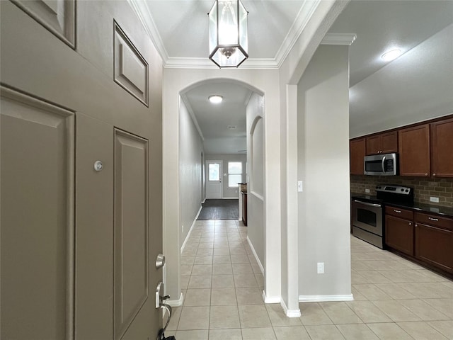 hall featuring light tile patterned floors and ornamental molding