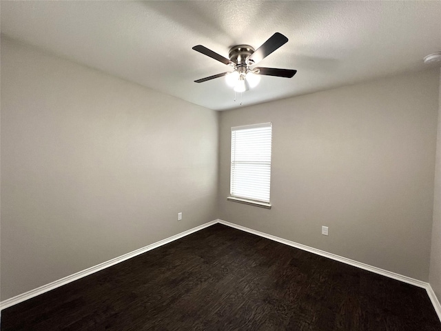 empty room with ceiling fan and wood-type flooring