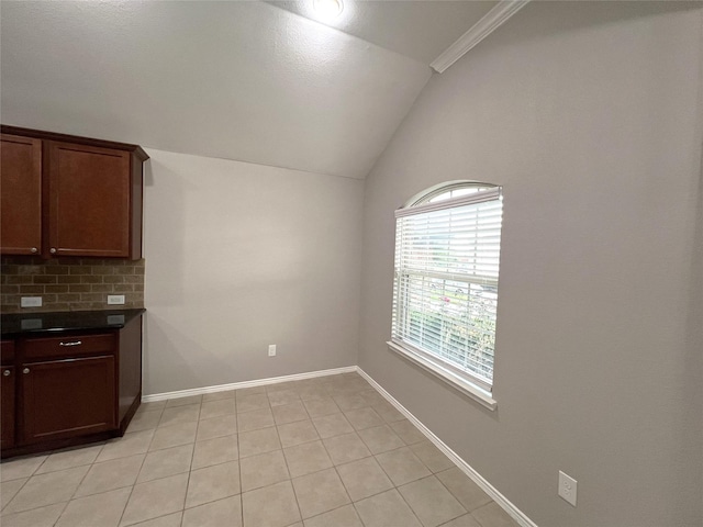 interior space with lofted ceiling and light tile patterned floors