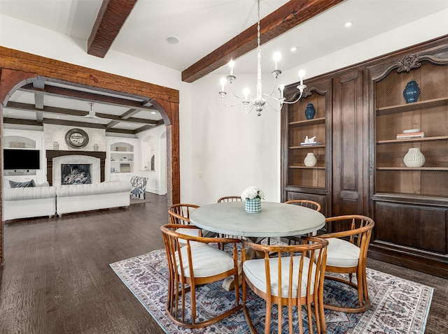 dining area featuring beamed ceiling, dark hardwood / wood-style floors, built in features, and a chandelier