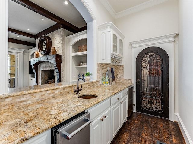 kitchen featuring stainless steel dishwasher, dark hardwood / wood-style flooring, sink, and white cabinets