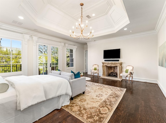 bedroom featuring crown molding, an inviting chandelier, access to outside, dark hardwood / wood-style floors, and a fireplace