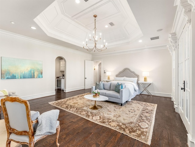 bedroom with dark hardwood / wood-style floors, ornamental molding, a raised ceiling, and a chandelier