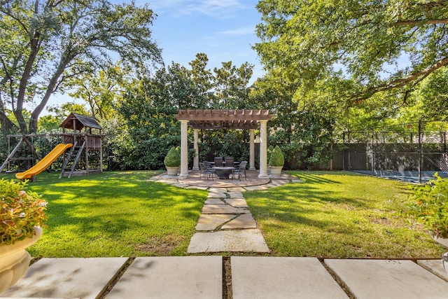 view of yard with a pergola, a playground, and a patio area