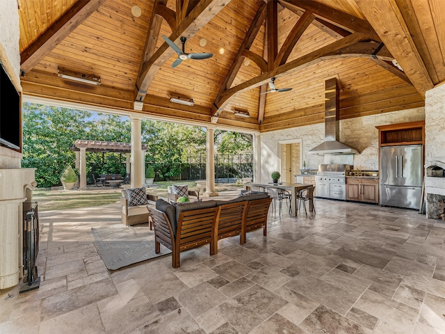 view of patio with area for grilling, exterior kitchen, ceiling fan, an outdoor living space, and a gazebo