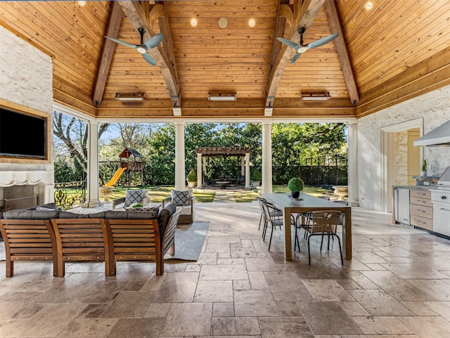 view of patio with ceiling fan, a gazebo, an outdoor living space, a playground, and exterior kitchen