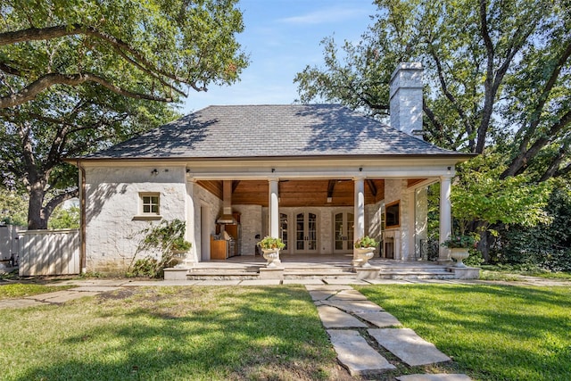 back of house with a lawn