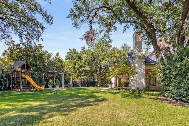 view of yard featuring a pergola and a playground