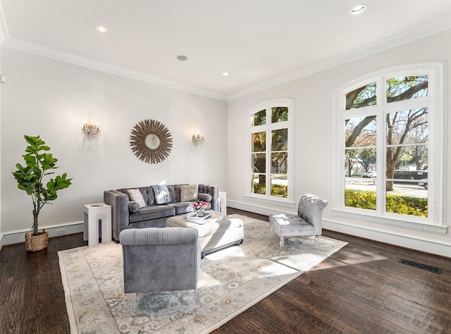 living room with dark hardwood / wood-style flooring and crown molding