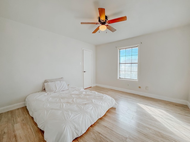 bedroom with ceiling fan and light wood-type flooring