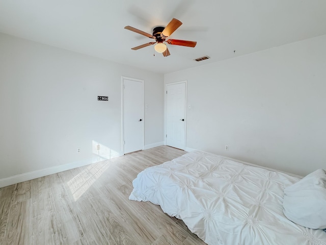 bedroom featuring light hardwood / wood-style flooring and ceiling fan