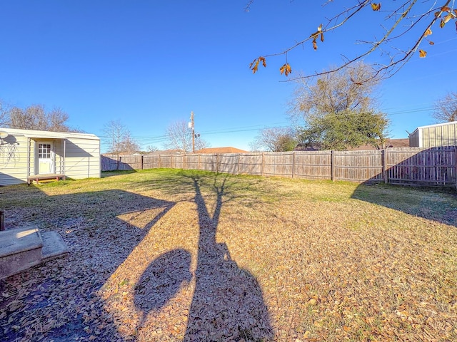 view of yard with entry steps and a fenced backyard