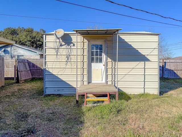 view of outbuilding featuring a yard