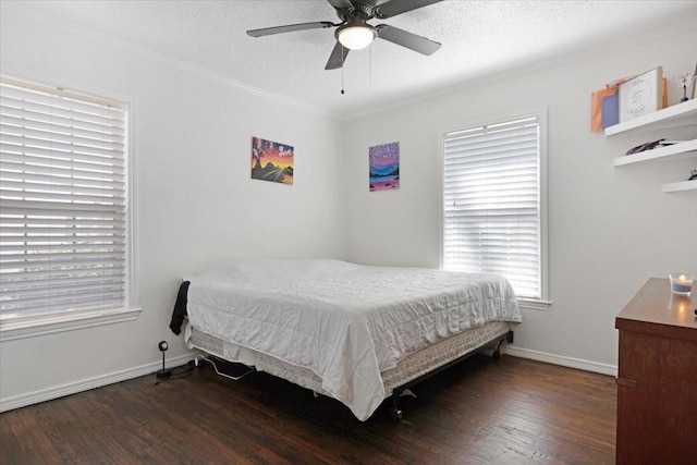 bedroom featuring ceiling fan, crown molding, a textured ceiling, and dark hardwood / wood-style flooring