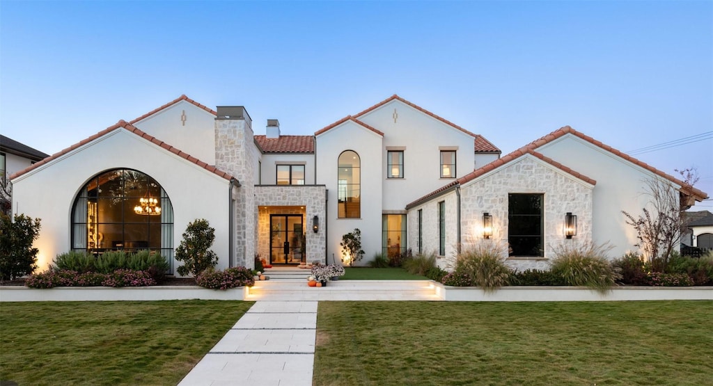 mediterranean / spanish-style home featuring a yard