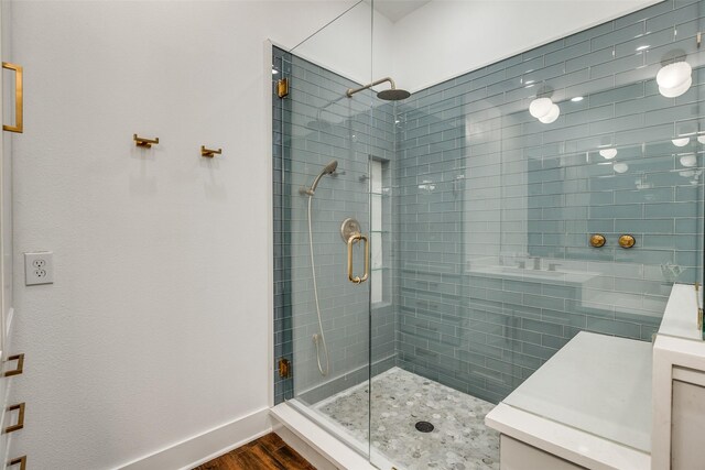 bathroom featuring a shower with door and hardwood / wood-style floors