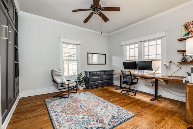 office space with dark wood-type flooring, ornamental molding, and a healthy amount of sunlight