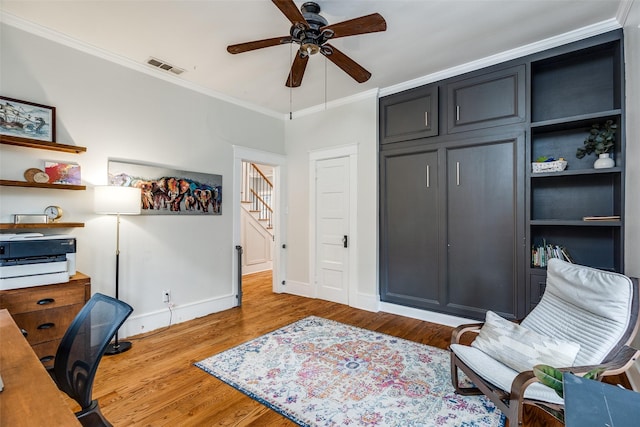 office space with crown molding, ceiling fan, and hardwood / wood-style flooring