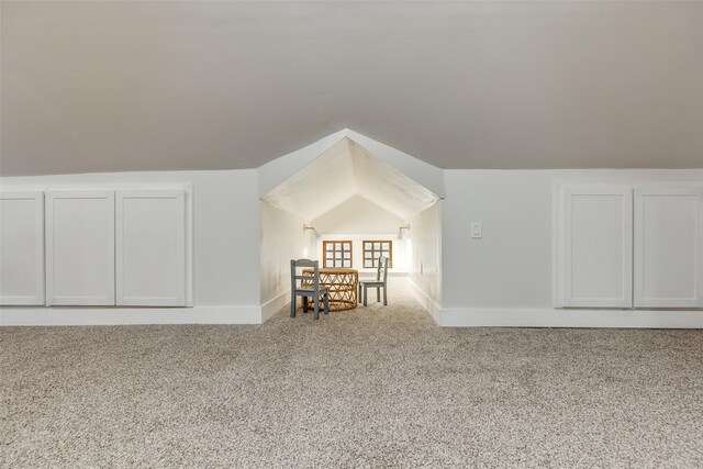 bonus room featuring lofted ceiling and carpet