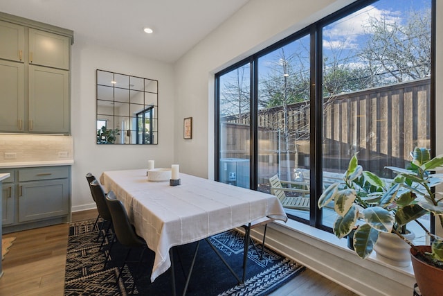 dining room featuring wood finished floors and recessed lighting