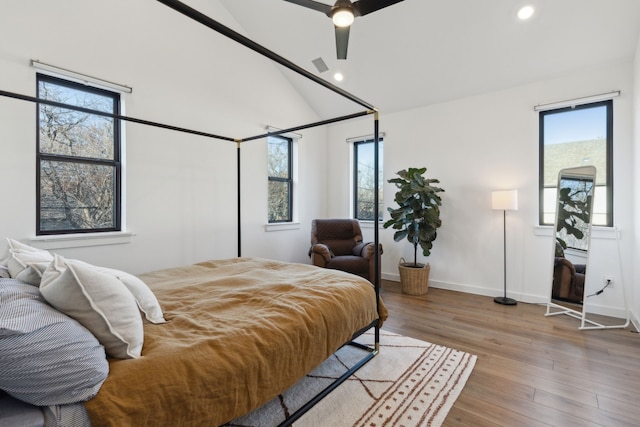 bedroom featuring multiple windows, wood finished floors, and recessed lighting