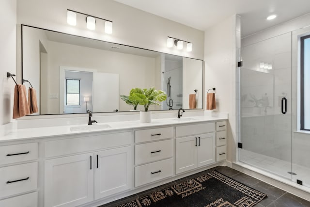 full bathroom featuring a stall shower, tile patterned flooring, and a sink