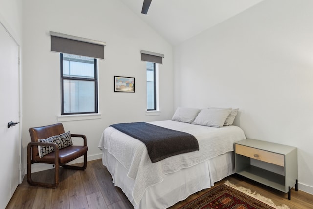 bedroom featuring ceiling fan, baseboards, vaulted ceiling, and hardwood / wood-style floors