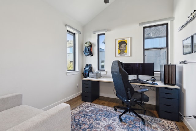 office area featuring vaulted ceiling, dark wood-style flooring, and baseboards