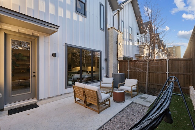 view of patio featuring central AC unit and fence