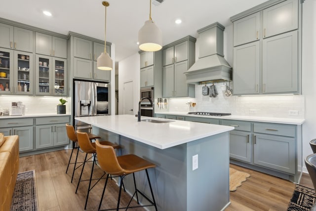 kitchen featuring premium range hood and gray cabinetry