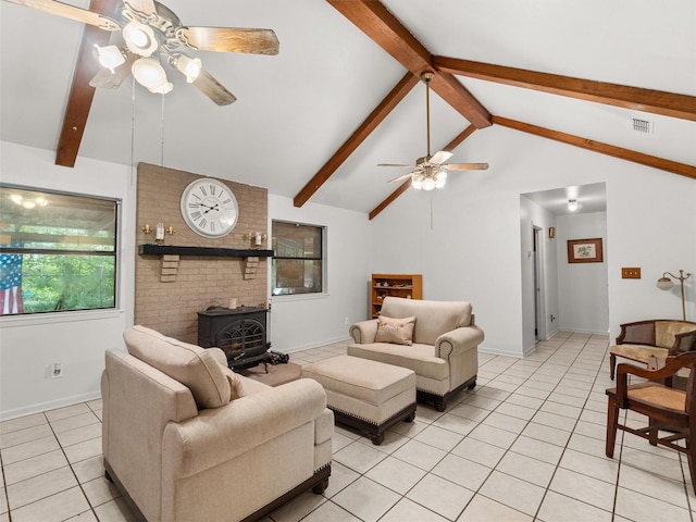 tiled living room featuring ceiling fan, high vaulted ceiling, beamed ceiling, and a wood stove