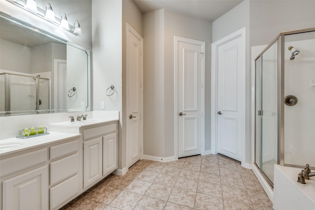 bathroom with an enclosed shower, vanity, and tile patterned floors