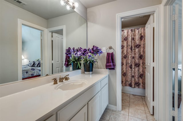 bathroom with vanity, a shower with curtain, and tile patterned floors