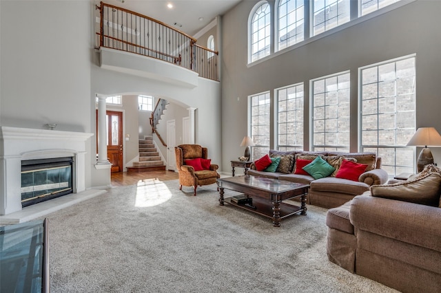 living room with carpet floors and ornate columns