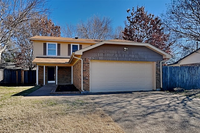 view of property with a garage and a front lawn