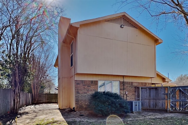 back of house featuring central air condition unit